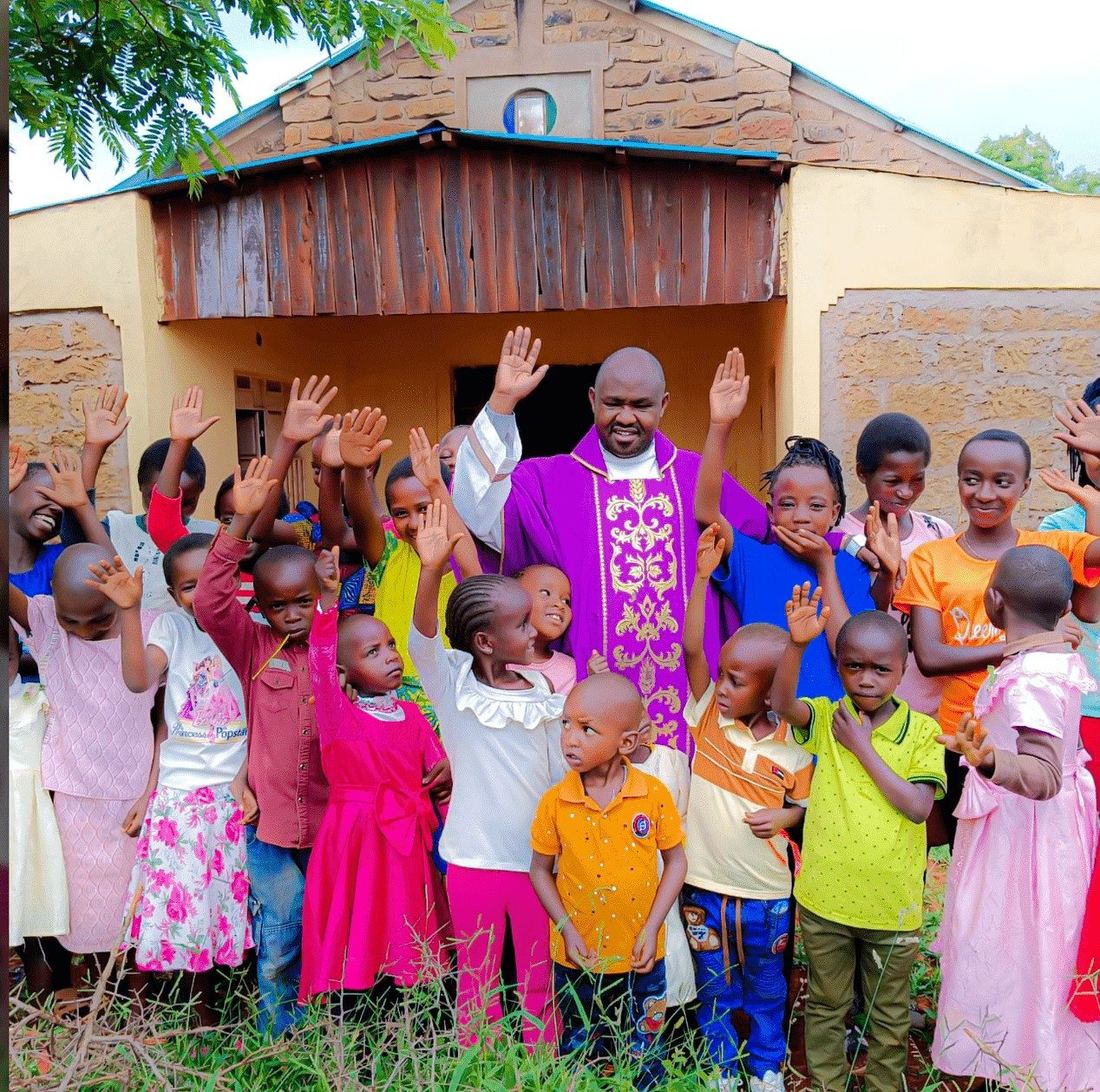 Fr. John Machali with children outside the parish church