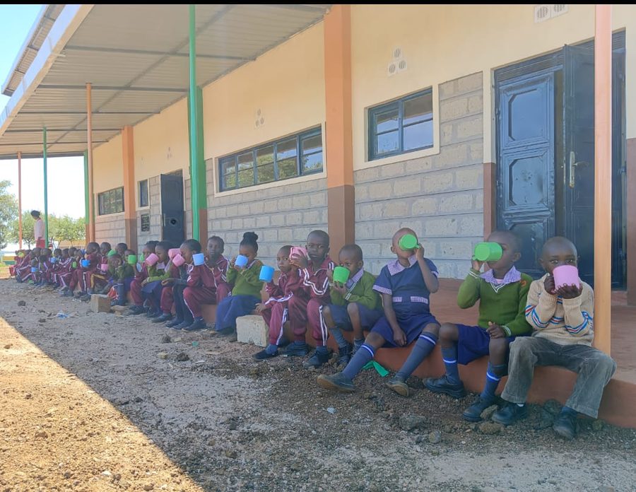 Pupils queuing outside the school building