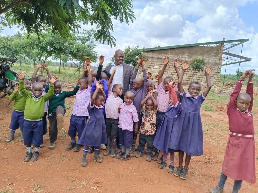 Schoolchildren celebrating at the site of the new kitchen
